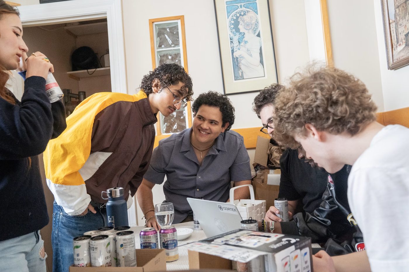 Founders gathered around a laptop at the dining table.