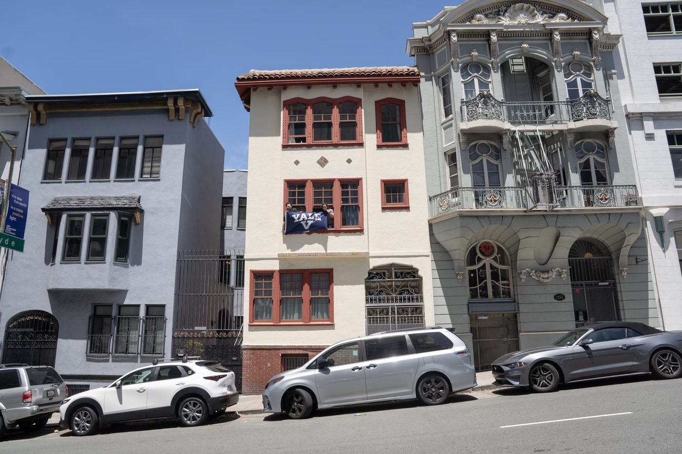 The Hacker House on Hyde Street, a Yale flag hung from a second-floor window.